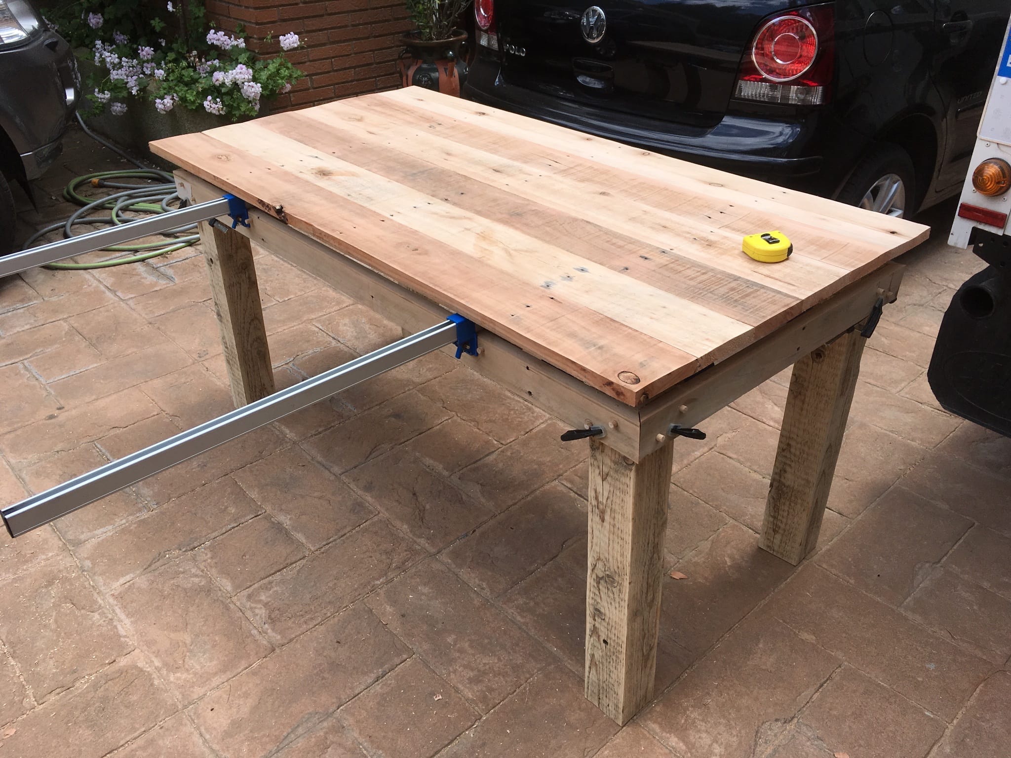 Attaching the frame to the legs with the table resting on top